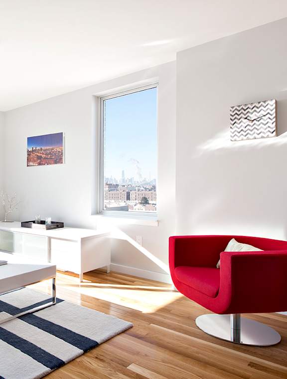 Living Room with Red Chair at The Icon 52 Apartments, Woodside