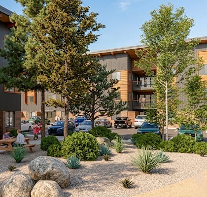 A modern building with wooden accents and a landscaped courtyard.
