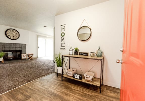 an open living room with a fireplace and a mirror on the wall at Crown Pointe, Lakewood, WA, 98499