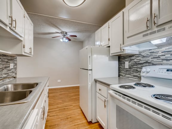 a kitchen with white appliances and white cabinets