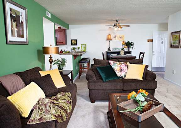 A living room with a brown couch and a coffee table.