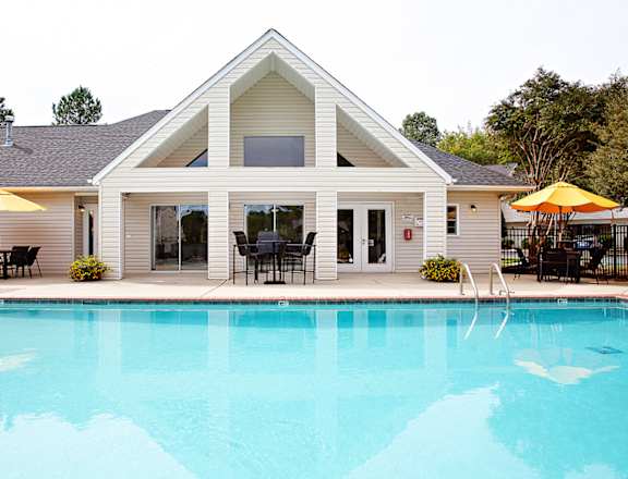 A house with a pool in front.