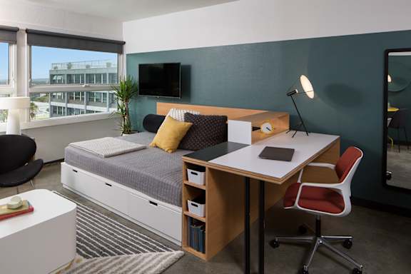 a small bedroom with a desk and a bed in it at The Flat in Los Angeles, California 90017