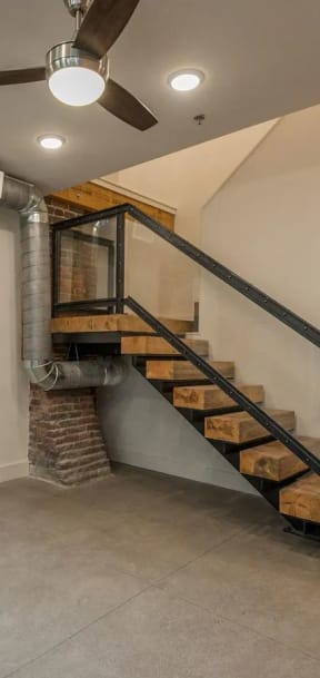 a basement with a staircase and exposed brick walls