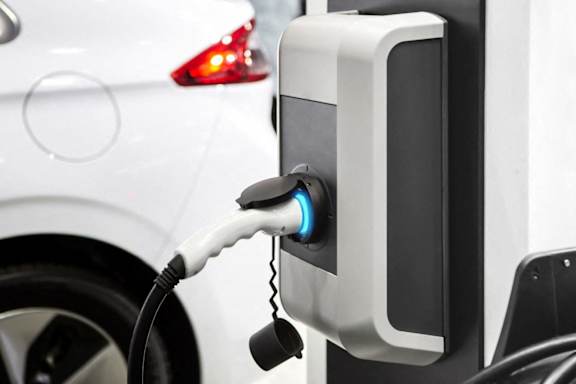 an electric car is charging at a charging station