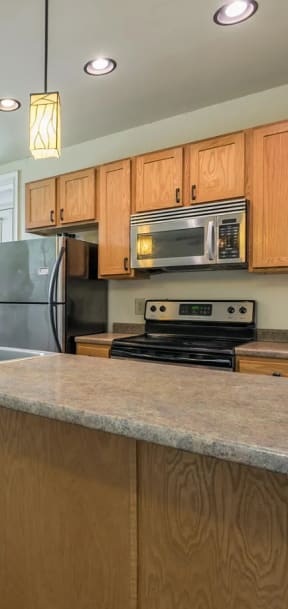 a kitchen with a large island with a sink and a stove