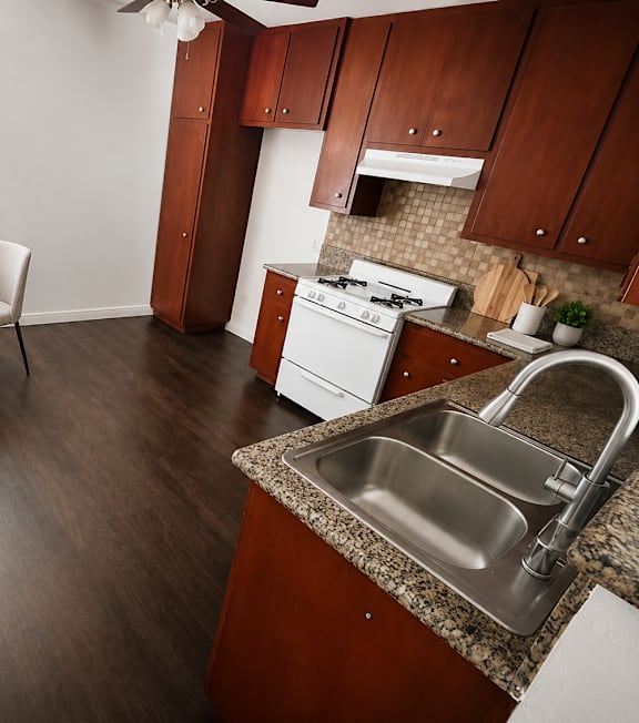 A well-lit, modern kitchen and living room with a dining area.