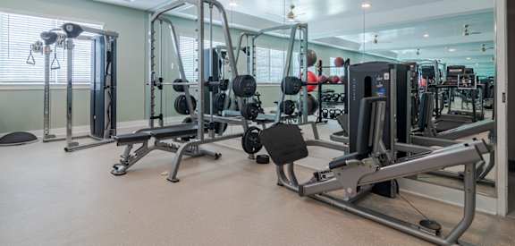 Fully equipped fitness center at Blue Sky Landing apartments in College Park, GA with cardio and strength training equipment near Atlanta Airport and Old National Highway.
