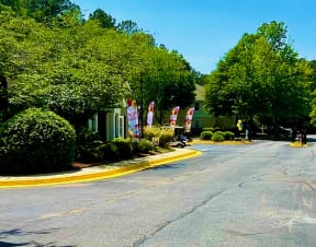 a street with a welcome home sign on the side at Hidden Creek, Morrow, GA