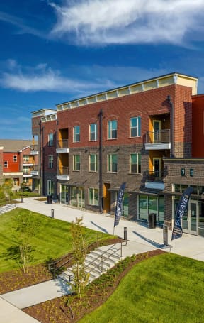a view of a building with a sidewalk and grass