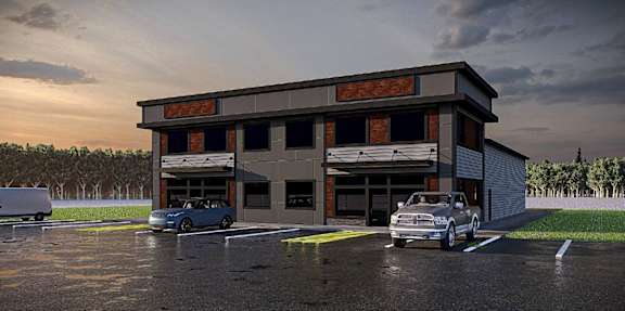 A car dealership with a blue car and a silver car in the foreground.