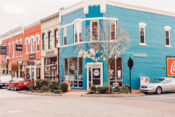a city street with a blue building on the corner