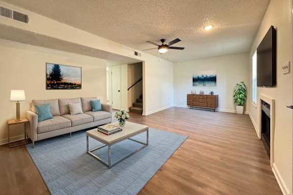 A living room with a grey sofa and a coffee table.