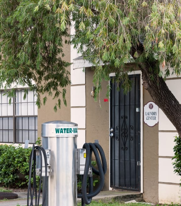 a water hydrant on the sidewalk in front of a building