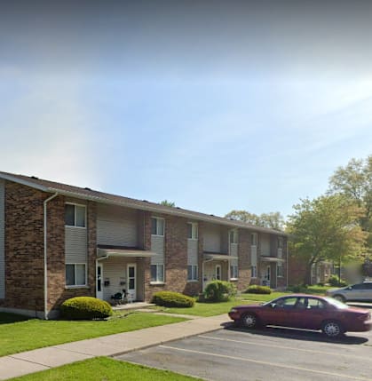 A building with a green lawn in front of it.