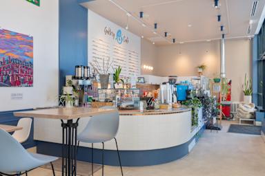A café with a white counter and a blue wall.