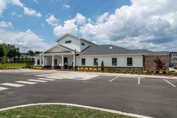Exterior view of Blue Sky Landing apartments in College Park, GA featuring modern community architecture near Old National Parkway, Camp Creek and Hartsfield-Jackson Atlanta International Airport.