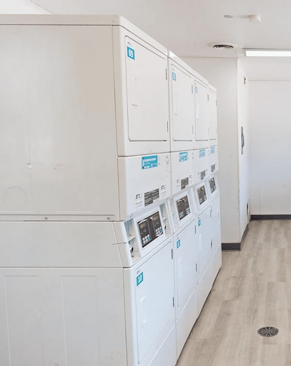 A laundry room with washers and dryers.