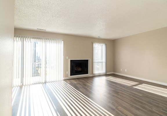 A living room with a fireplace and a television.