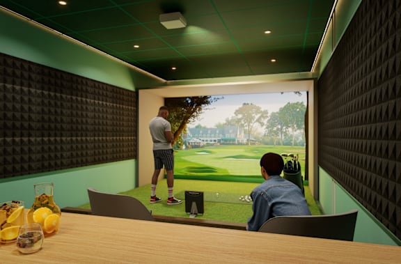 Two men are watching a cricket match on a large screen in a room with a green wall.
