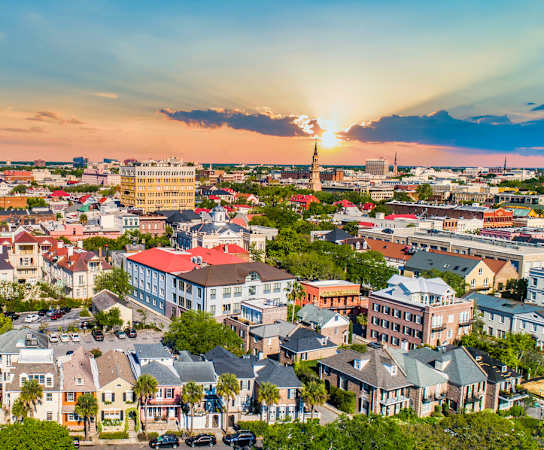 a cityscape with a sunset in the background at Wharf 7 Apartments, South Carolina, 29492