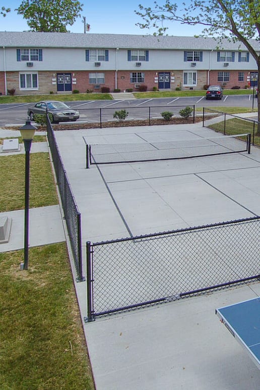 an aerial view of a tennis court in a parking lot