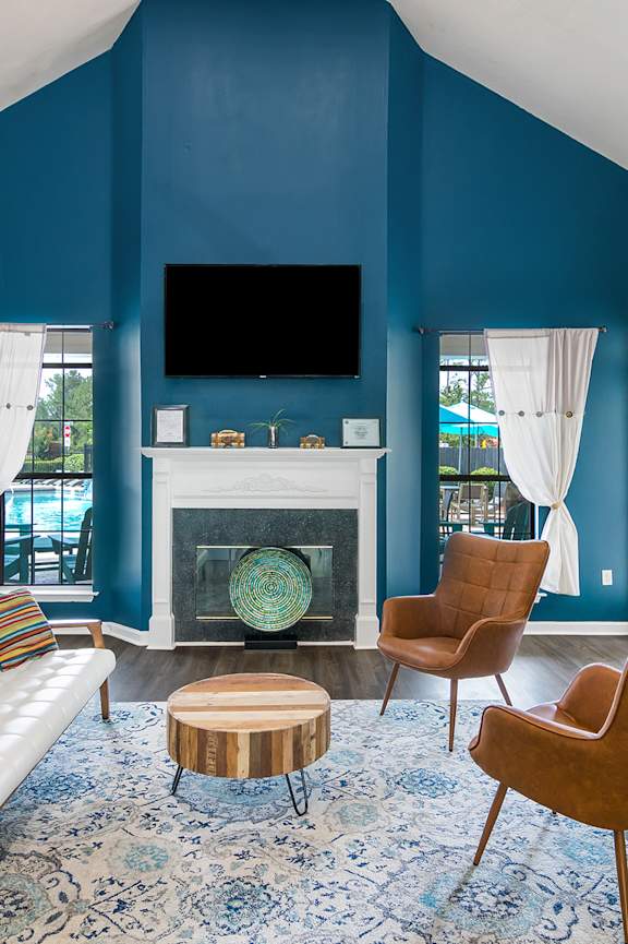 A living room with a fireplace and a television.