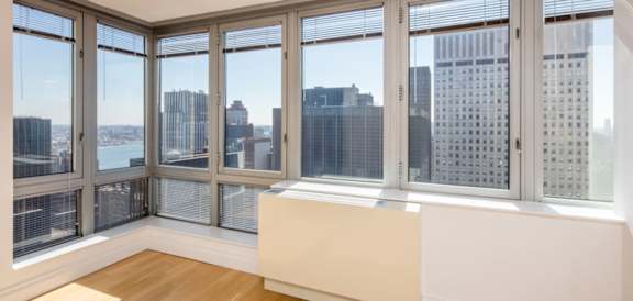 A room with a view of the city through large windows.at 'The Metropolis', New York