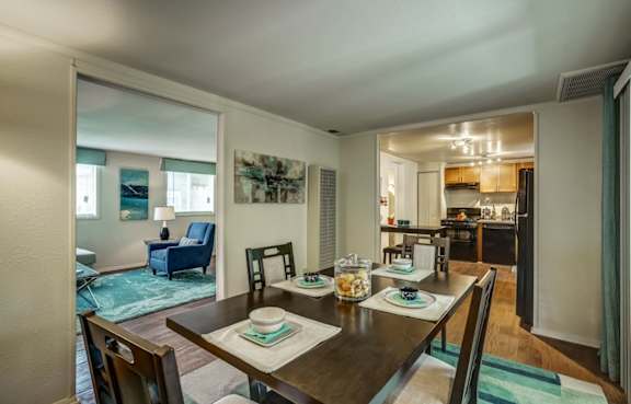 A dining room with a table set for two.
