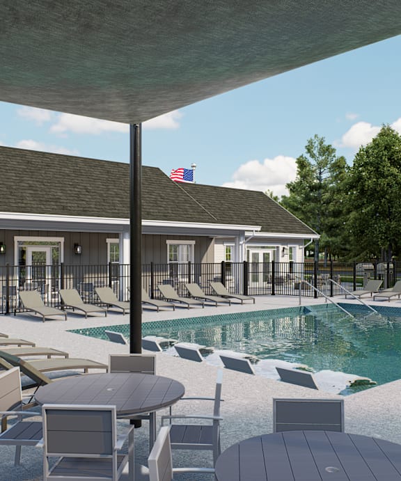 A poolside area with lounge chairs and a table at Solhaven Grand Chute, Appleton, WI