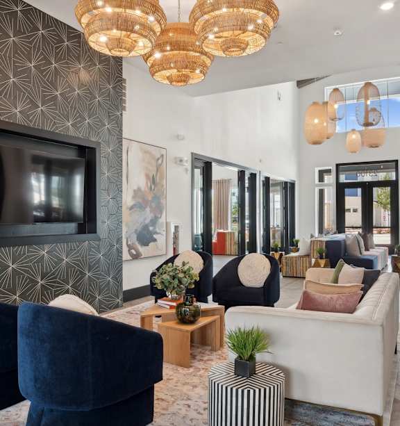 A living room with a dark patterned wall and a flat screen TV.