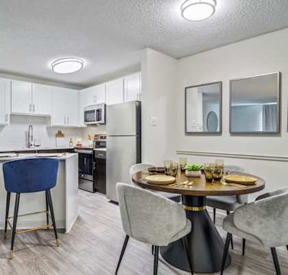 a kitchen and dining room with a table and chairs
