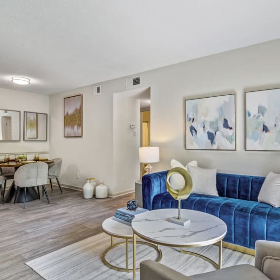 a living room with a blue couch and a table