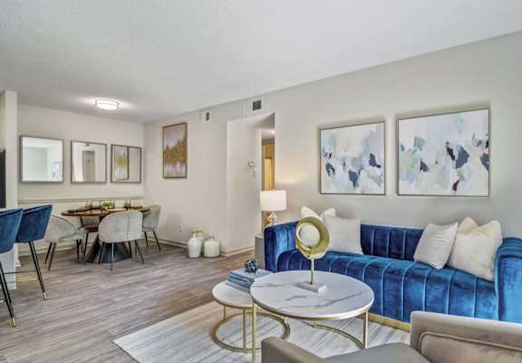 a living room with a blue couch and a table