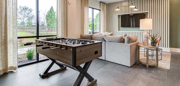 Sky Harbor Apartments in Chamblee, GA photo of a a games room with a foosball table and a couch