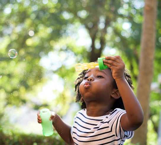 Child blowing bubbles