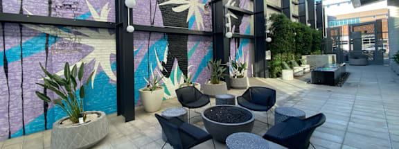 A mural of a person and a plant is painted on a wall.