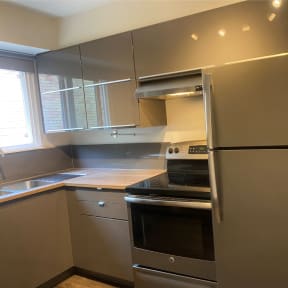 a kitchen with a stainless steel refrigerator and a stove
