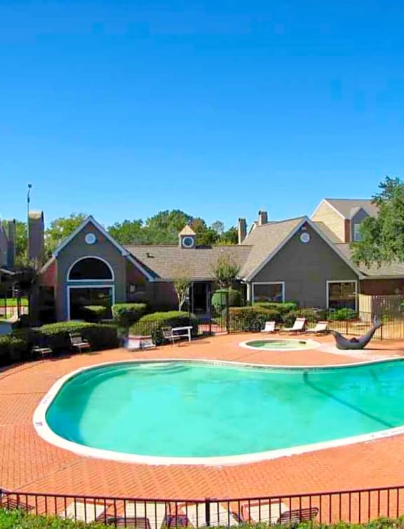 a swimming pool with houses in the background
