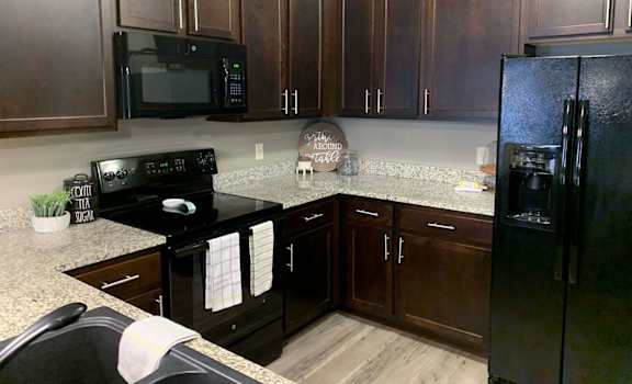 a kitchen with black appliances and granite counter tops