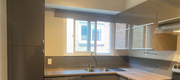 an empty kitchen with a sink and a window