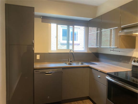 an empty kitchen with a sink and a window