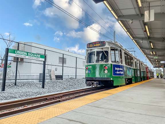 A green train is at Union Square station.