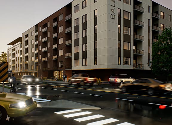 A modern building named Balade is depicted with cars passing by on the street in front of it.