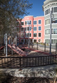 people sitting on benches in front of a tall building