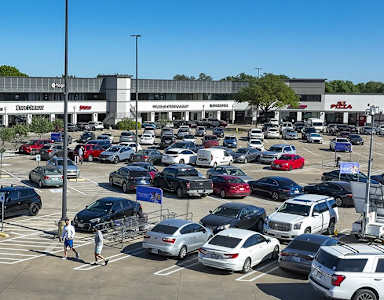 A Kroger store with a parking lot full of cars.