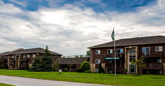 Apartment buildings with a green lawn at Condor Garden Apartments, Elyria, OH