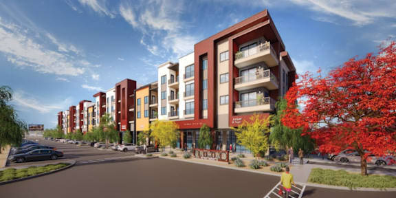 A row of modern apartment buildings with trees in front.