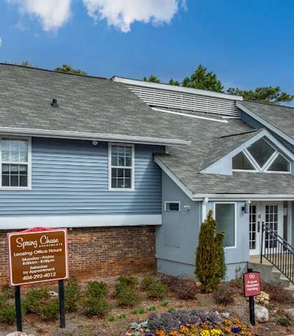 a blue house with a sign in front of it