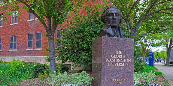 A bust of a man is on a pedestal with the words "The George Washington University" written on it.